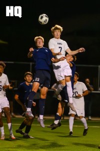 La Cueva’s Sebastian Kreuter (23) Tanner Groves (7) of Rio Rancho both brace mid-air in preparation to head the ball during their semifinals matchup of the APS Metro Soccer Championships.