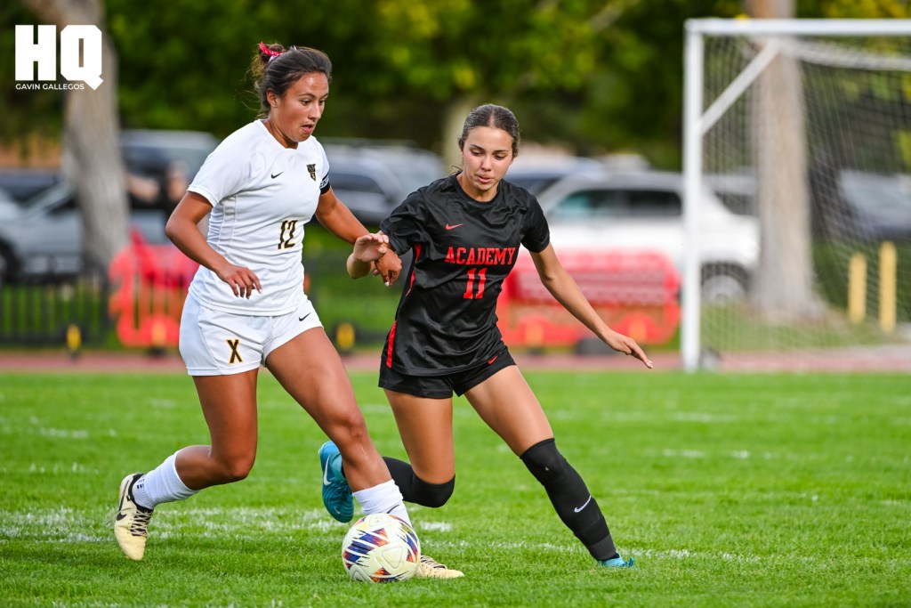 Maddilyn Garcia (12) of St. Pius X shields the ball from Albuquerque Academy’s pressuring Analucia Torres-Rael (11) in their non-district matchup at Richard Harper Memorial Field in Albuquerque, NM. Gavin Gallegos/HQ Sports