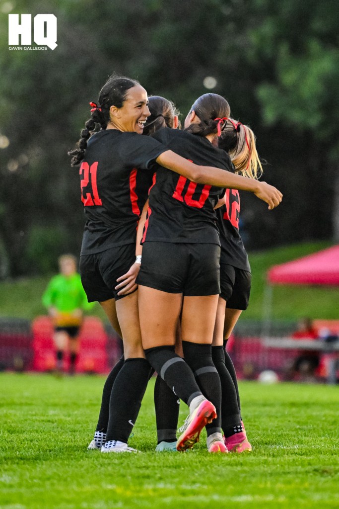 Selena Broussard (21) and members of the Albuquerque Academy girls soccer team celebrate following their overtime victory over St. Pius X in a non-district match at Richard Harper Memorial Field on the campus of Albuquerque Academy on September 16, 2025. Gavin Gallegos/HQ Sports