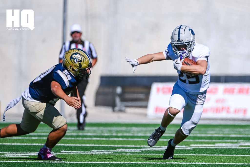 J Hathaway, (29) a sophomore La Cueva running back stiff arms against an Atrisco Heritage Academy defender during a matchup against each other at Nusenda Community Stadium. Gavin Gallegos/HQ Sports