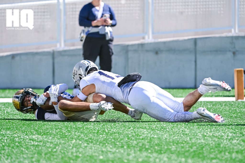 La Cueva's Chris Lopez, (13) a sophomore wide receiver brings down an Atrisco Heritage Academy player in the end zone during a district matchup against each other at Nusenda Community Stadium. Gavin Gallegos/HQ Sports