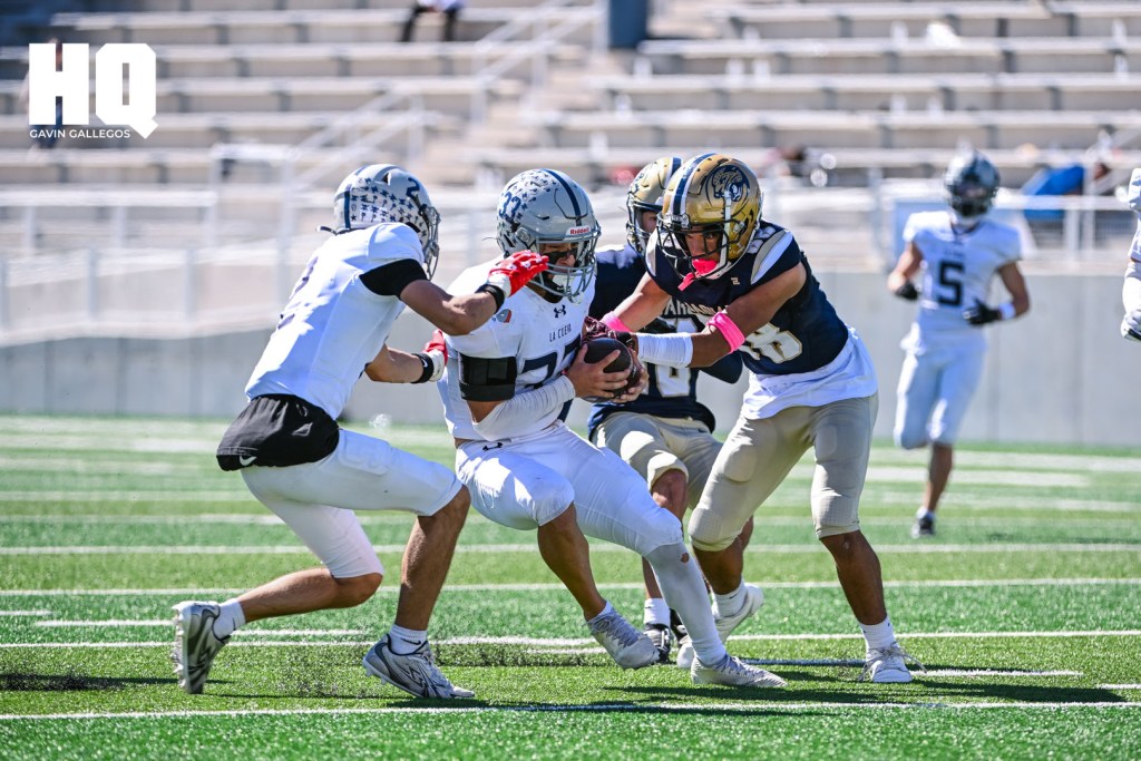 An Atrisco Heritage Academy player attempts to stop La Cueva's Mickey Widner (33) near the end zone to stop his advancement of the ball. Gavin Gallegos/HQ Sports